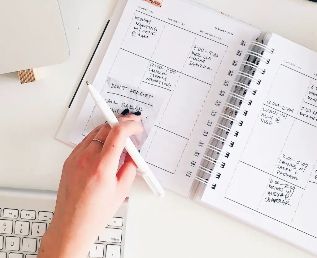 woman looking at calendar to pick dates for an international trip